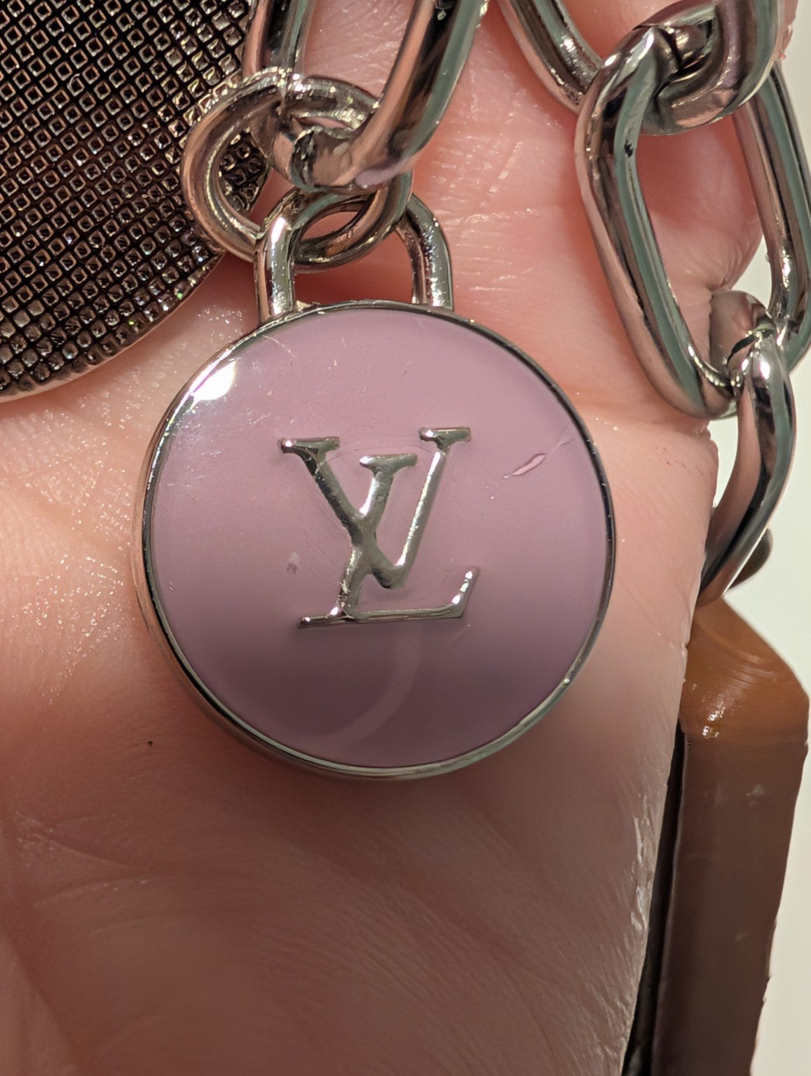 Close-up of lavender upcycled LV charm with silver plating