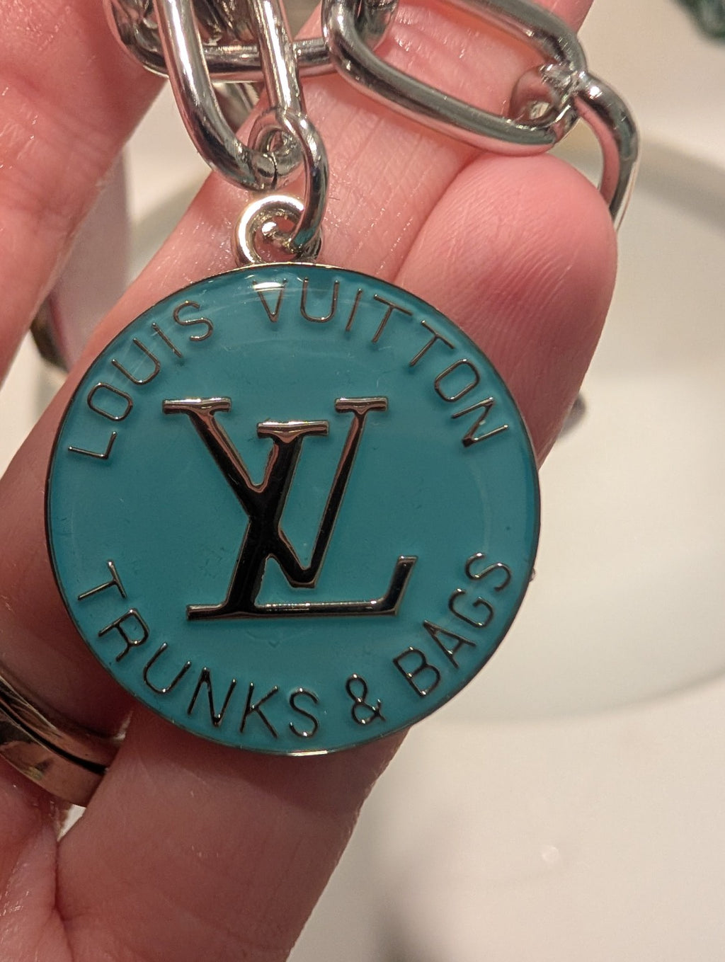 Close-up of turquoise upcycled LV Trunks & Bags charm