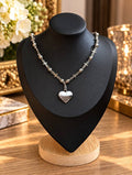 19-inch silver-tone Dream Booth necklace with ornate beads and an upcycled Prada heart on a black display bust