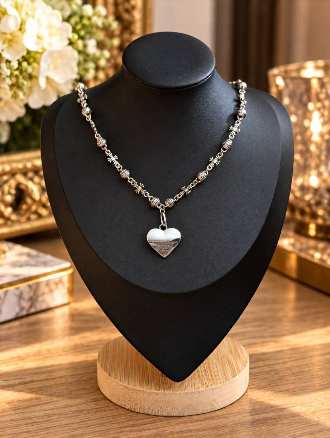 19-inch silver-tone Dream Booth necklace with ornate beads and an upcycled Prada heart on a black display bust