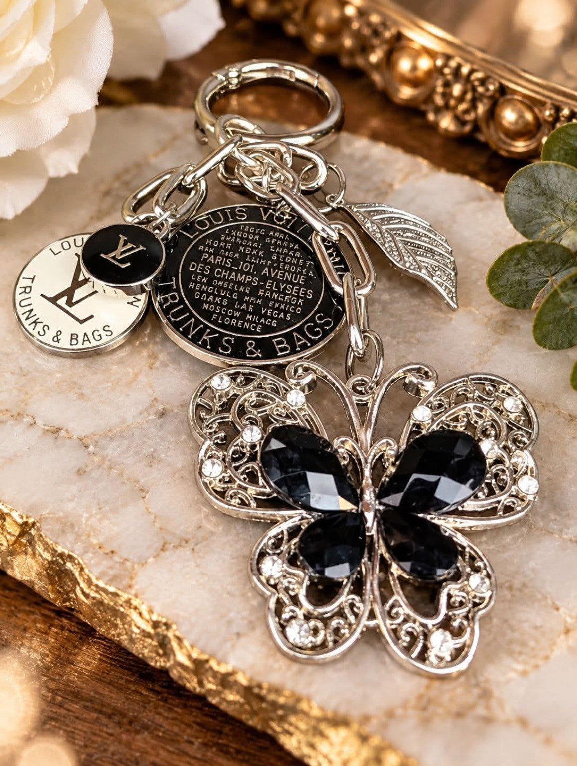 Midnight Flutter bag charm with a black jeweled vintage butterfly, silver-tone links, a leaf charm and upcycled LV pieces