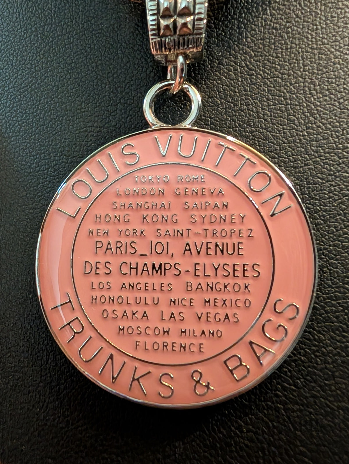 Close-up of the pink LV Trunks & Bags medallion