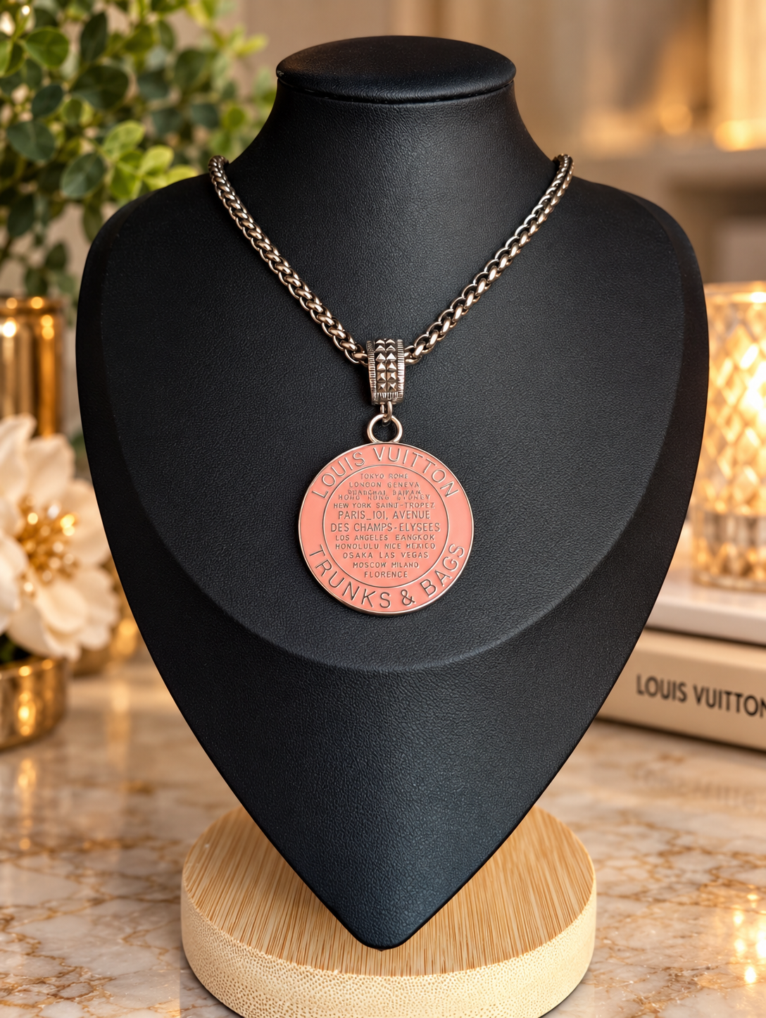 18-inch vintage silver-tone necklace with an upcycled pink LV Trunks & Bags charm on a display bust