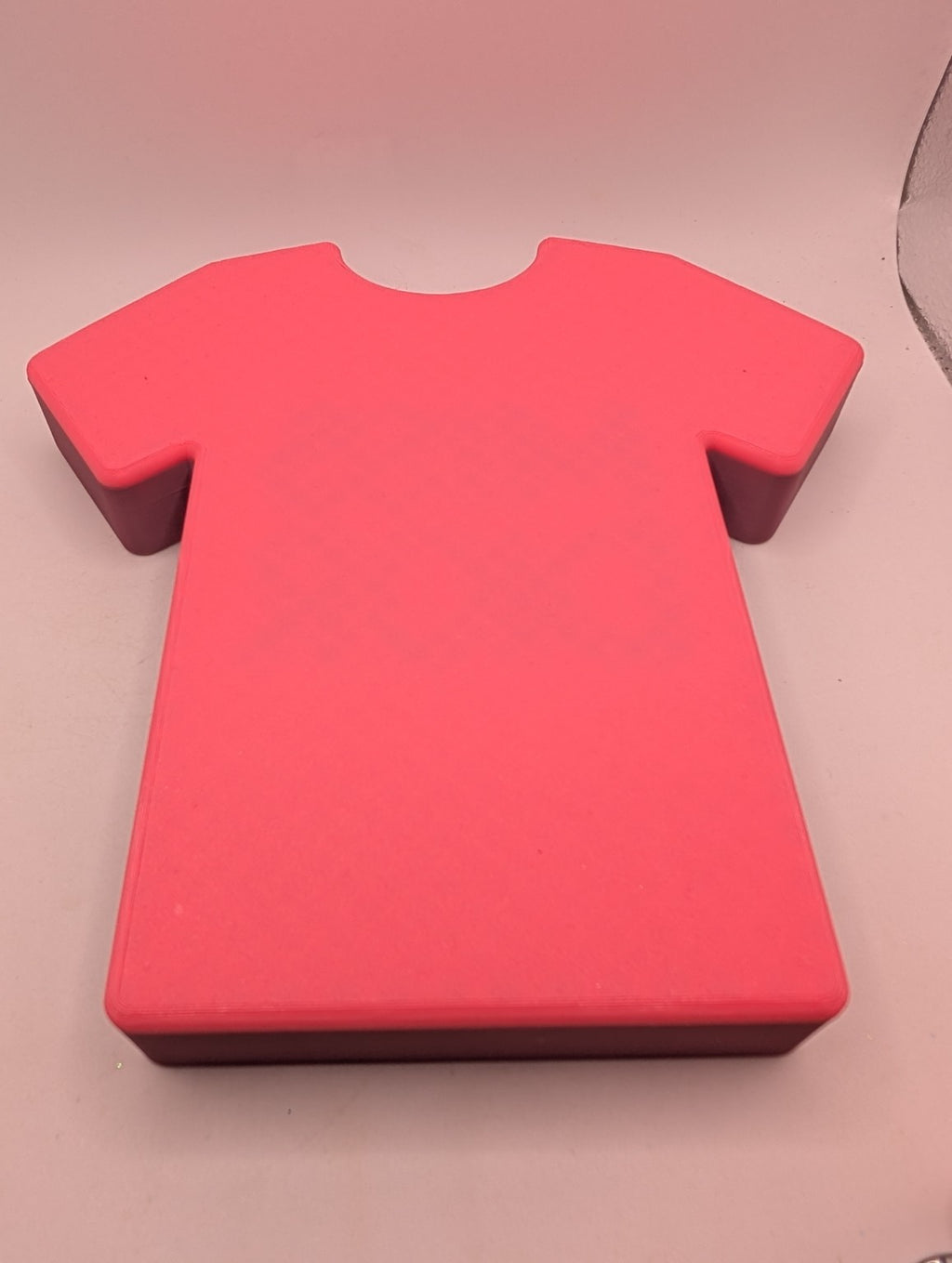 Hot-pink underside of the tee-shaped jewelry tray