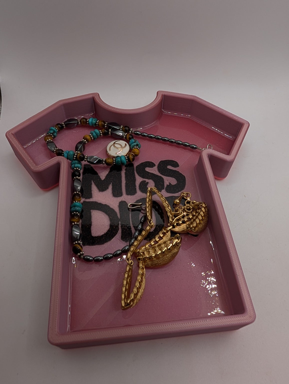 Rose-gold glitter tee tray holding jewelry