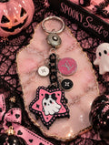 Spooky Sweet pink and black ghost bag charm with chunky black links, a silver-tone spinning connector and an upcycled pink LV medallion
