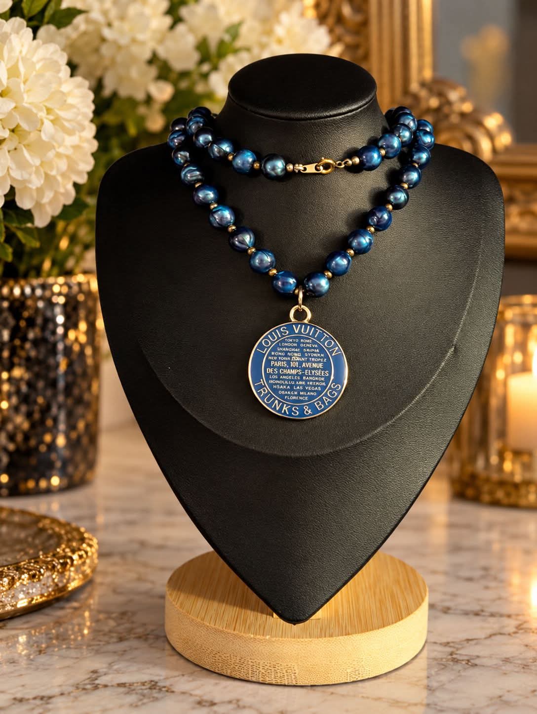 The Velvet Hour deep blue double-strand pearl-style necklace with upcycled LV centerpiece